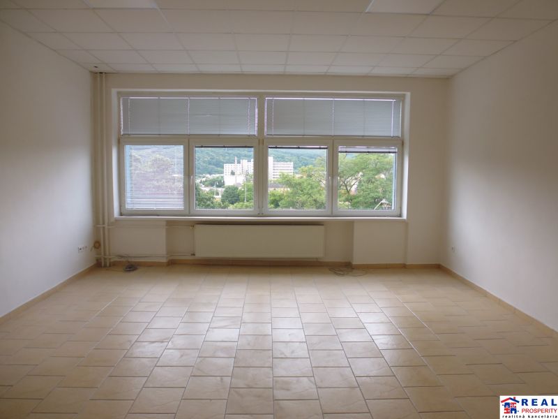 Spacious offices with tiled floors and large windows with a view.