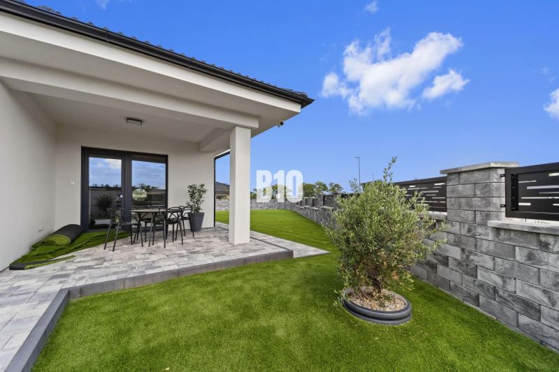 A family house in Nitra with a terrace, garden, and modern fencing.