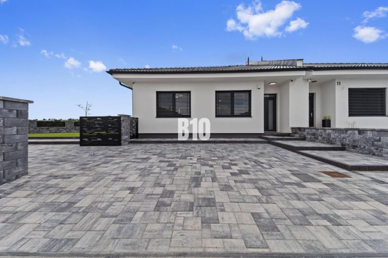 A family house in Nitra with stone paving and a simple exterior design.