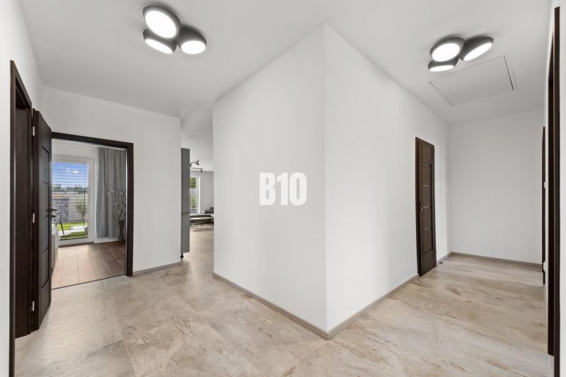 The interior of a family house with white walls and tiles in a neutral shade.