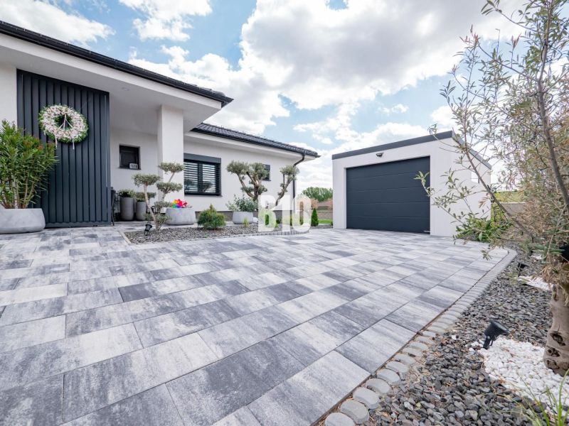 A family house in Nitra with paving, a garage, and a decorative entrance.