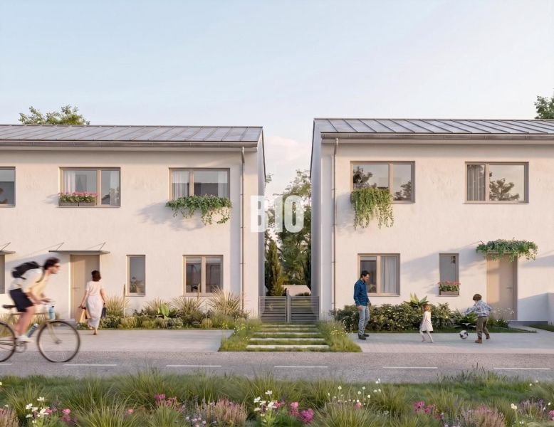 Family houses in Nitra with landscaped gardens, people cycling and playing.