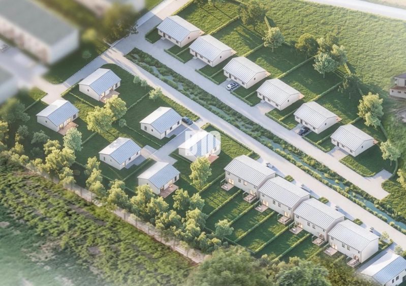 Aerial view of family houses in a residential area in Nitra surrounded by greenery.