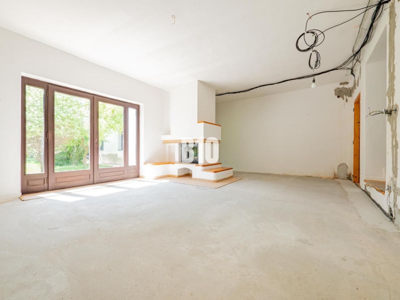 A family house with large windows and a fireplace, waiting for the interior to be completed.