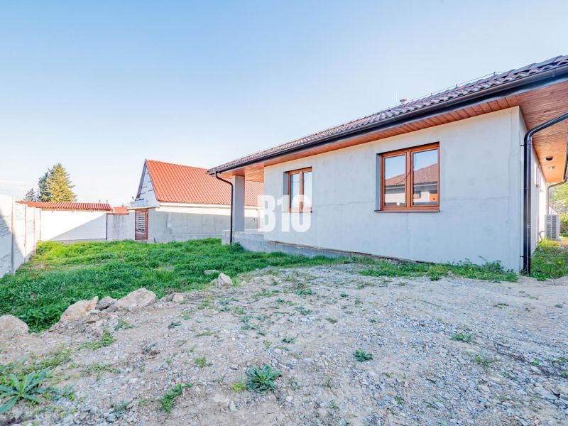 A family house in Nitra with a brick facade and a sloping red roof.