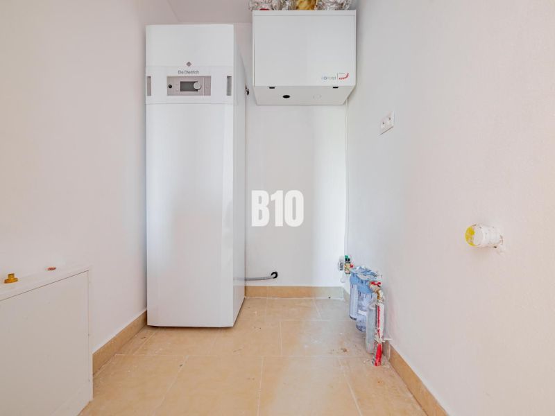 A utility room with equipment in a family house, containing modern technologies for efficient heating.
