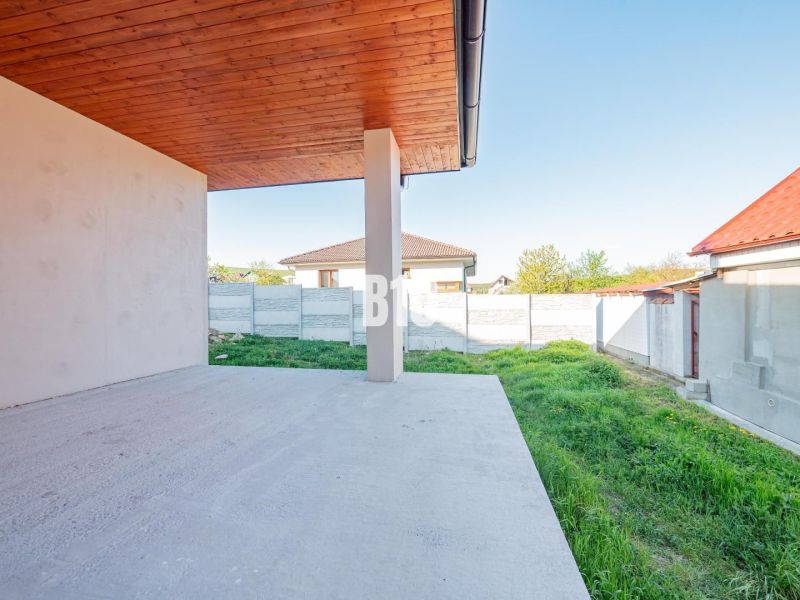 A family house in Nitra with a terrace and a view of the garden with a grassed area.