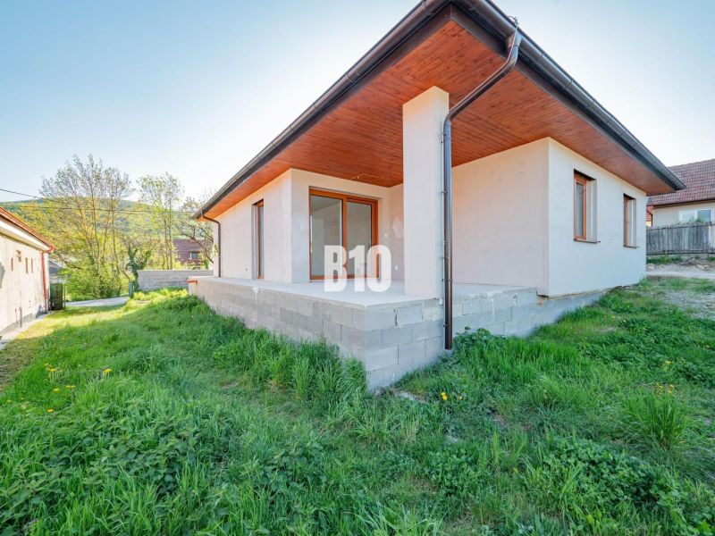 A family house in Nitra with a concrete terrace and a green lawn in the garden.