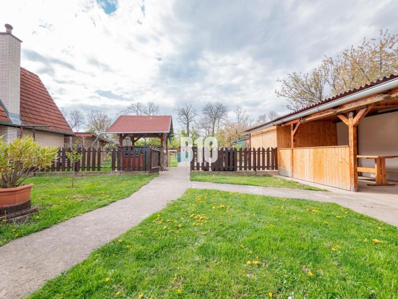 Nitra, family house, garden with wooden gazebo, walkway, and fencing.