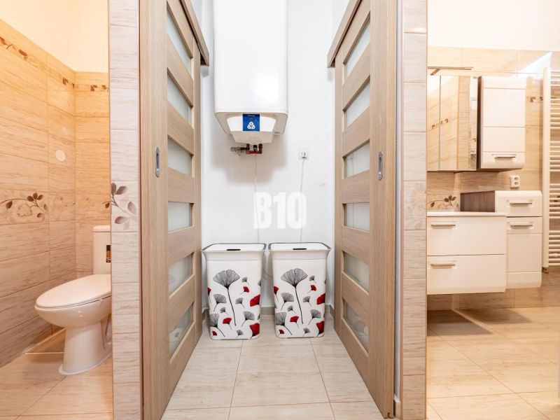 Bathroom and toilet in a family house with tiles and sliding doors.