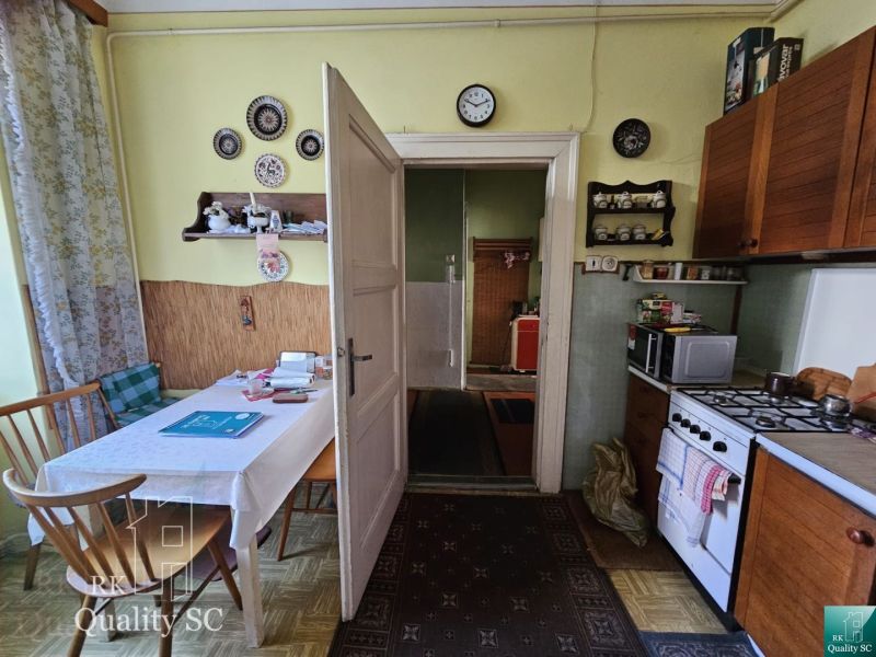 A kitchen in a 2-room apartment with retro decor and a dining table.