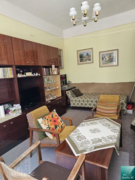 Living room in a two-room apartment with retro furniture and decorative elements.