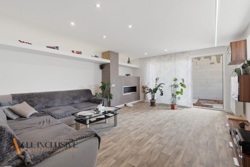 Living room in a family house with comfortable seating and a wooden decor floor.