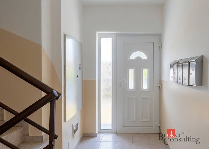 Entrance hall of a 4-room apartment with a staircase and mailboxes.