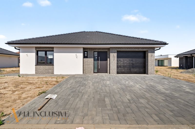 A family house in Hviezdoslavov with a brick facade and a spacious paved driveway.