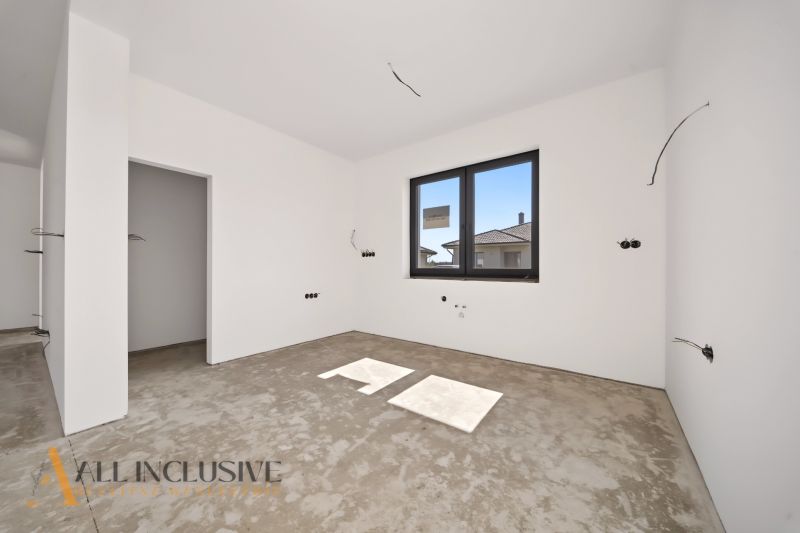 An empty room with a window and prepared electrical installation in a family house.
