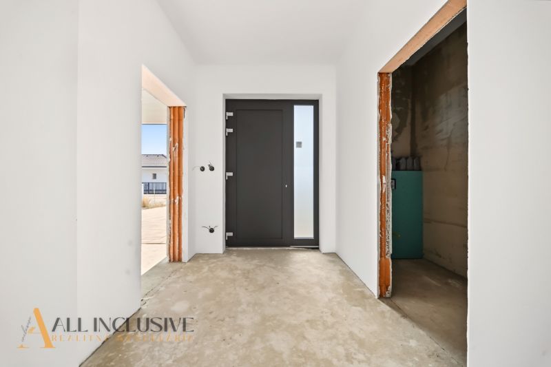Entrance area in a family house with white walls and dark doors.
