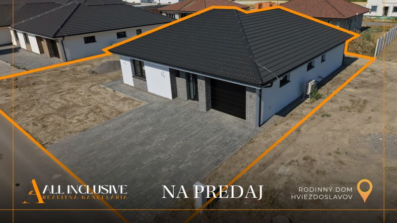 A family house in Hviezdoslavov with a dark roof and a paved courtyard, for sale.