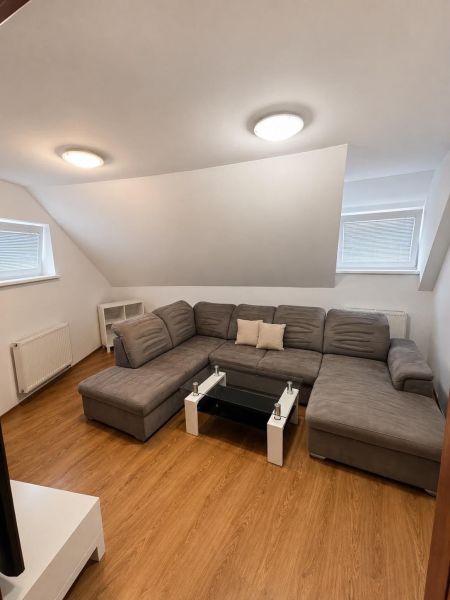 A comfortable sofa in a 2-room apartment on a floor with a wooden decor.