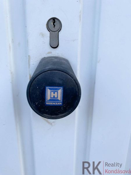 Lock and handle on white doors in garages on Belanska Street in Košice.