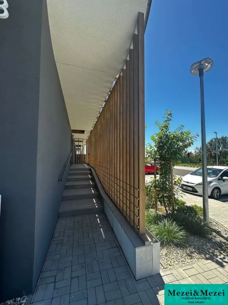 Entrance via stairs with wooden railing on Gen. Golián Street, Trnava.