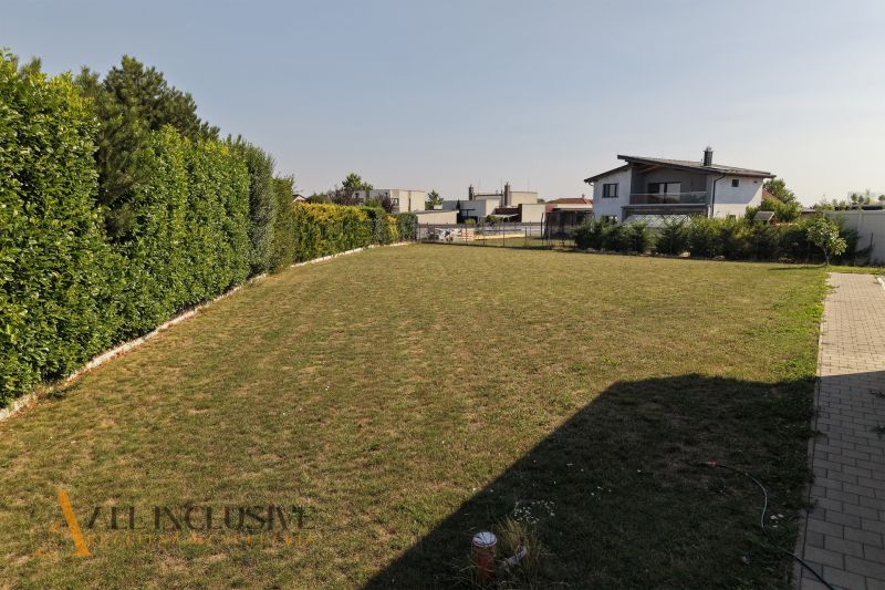 A grassy plot with tall hedges, on Mlynský Klin Street in Senec, Land - residential.