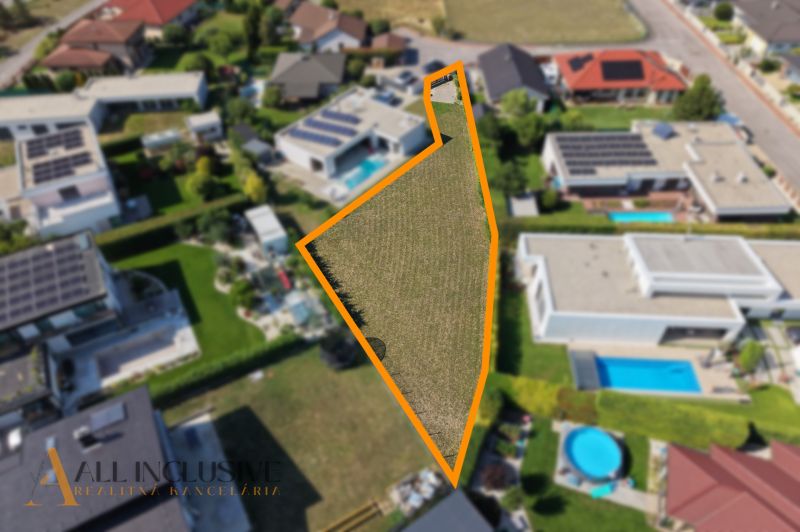 A residential plot on Mlynský Klin in Senec, surrounded by family houses.