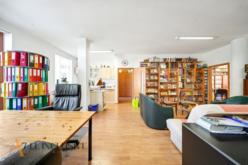 A spacious living room with a library and wood-patterned flooring in a 3-room apartment.