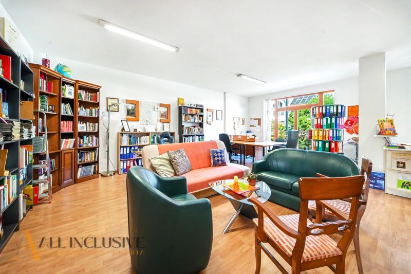 Comfortable seating and bookshelves in a 3-room apartment with a wooden decor floor.