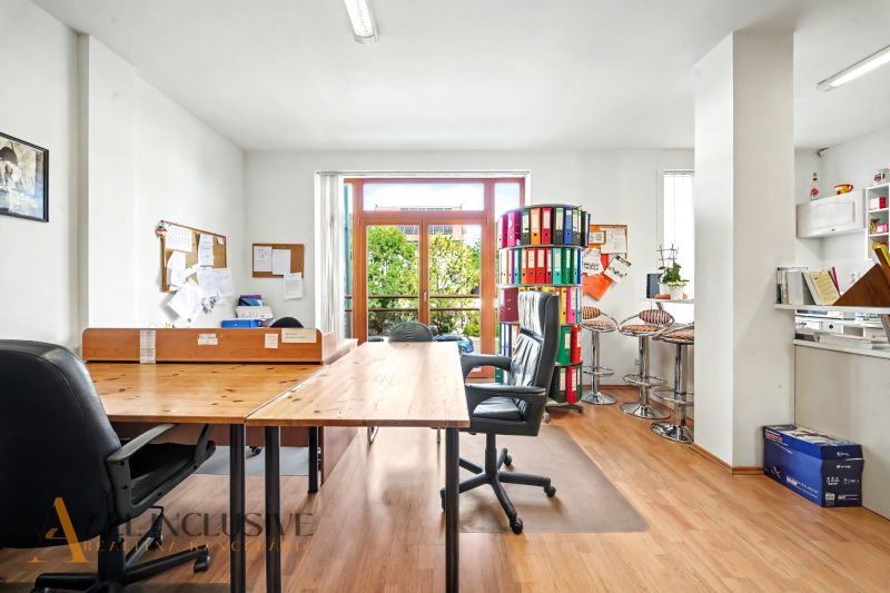 Office space in a 3-room apartment with office furniture and a wooden decor floor.