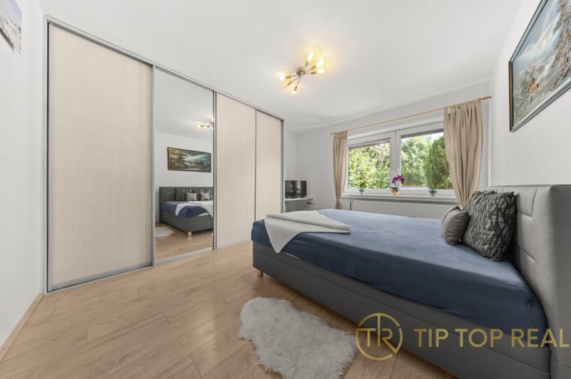 Bedroom in a family house with a wardrobe and a wooden decor floor.