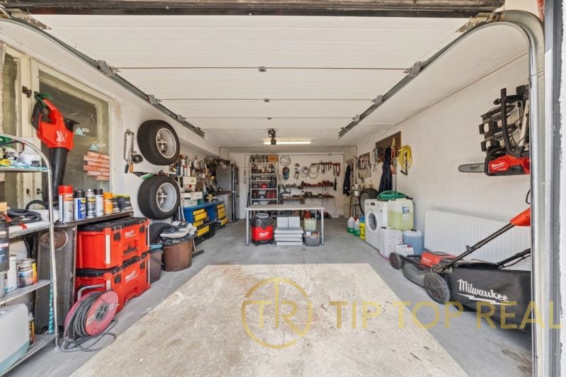 A garage in a family house with tools and instruments on the shelves.