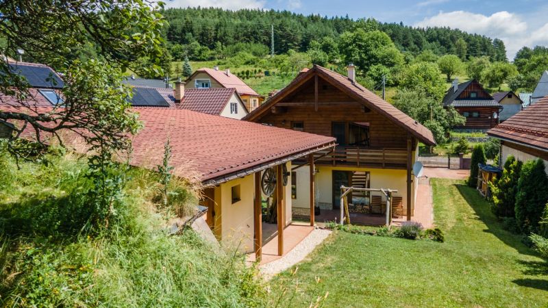 A family house in Horná Lehota with a red roof and surrounding greenery.