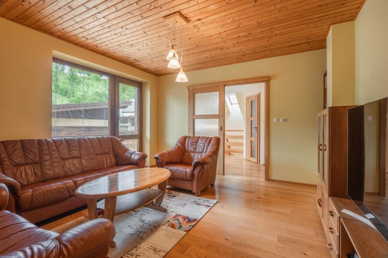 Living room in a family house with a sofa set and a wooden decor floor.