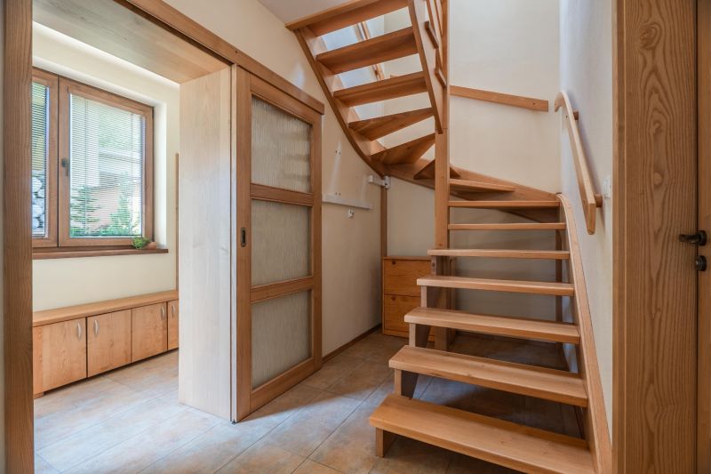 Interior of a family house with a wooden staircase and sliding doors.