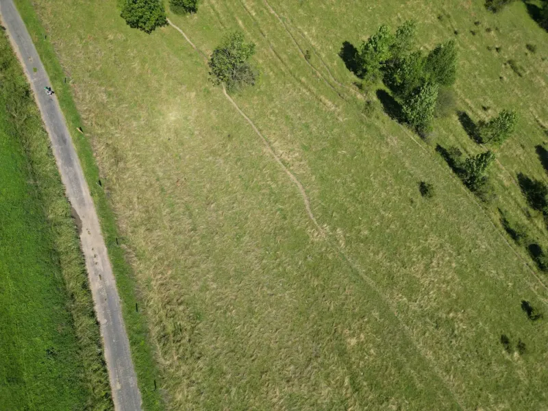 Aerial photograph of the landscape near Stará Ľubovňa, highlighting green meadows and tree scenery.