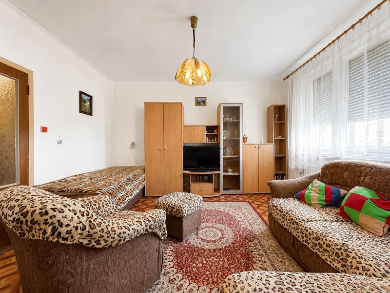Living room in a studio apartment with sofas and a wooden decor floor.