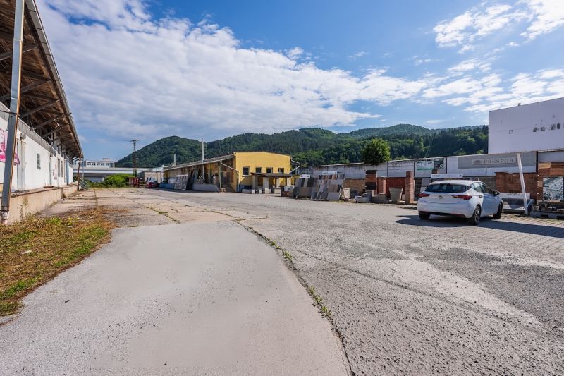 Exterior of the building on Zvolenská Road, Banská Bystrica, with a mountain backdrop and sky.