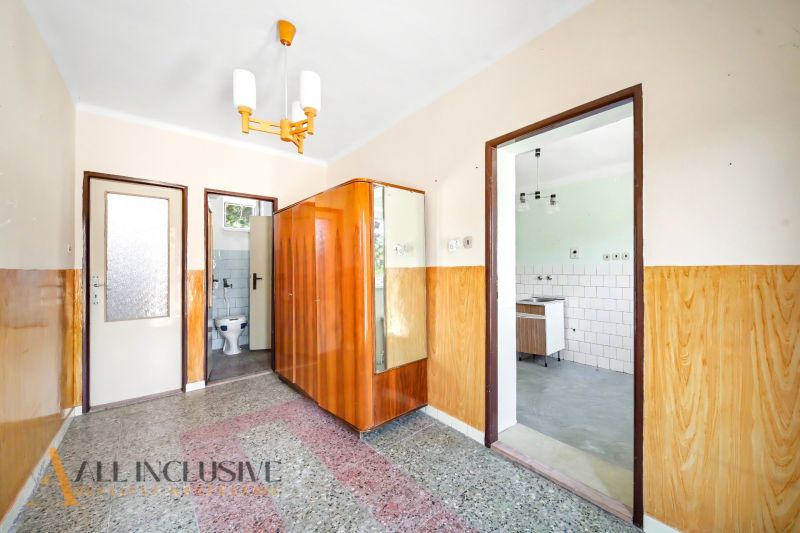 A hallway in a family house with wooden decor and a bathroom.