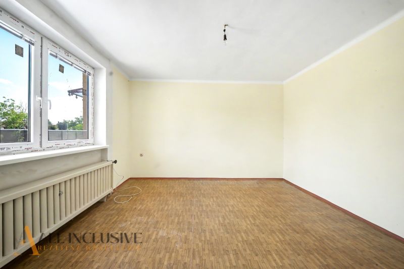 An empty room with a wooden decor floor in a family house.
