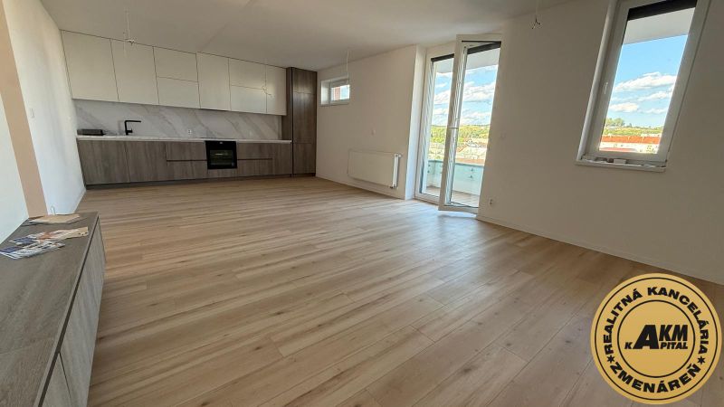 Kitchen and living area with wood-patterned flooring in a 3-room apartment.