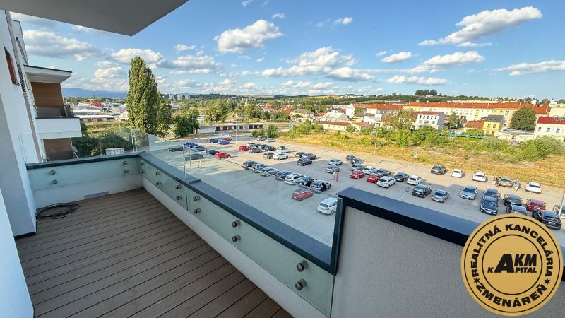 A balcony with a wooden decor floor offers a view of Zvolen, Kubániho Street.