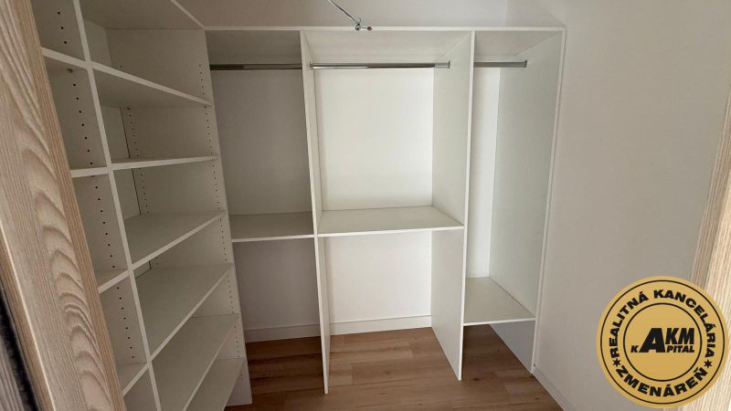 Built-in wardrobe in a 3-room apartment, with a wooden decor floor.