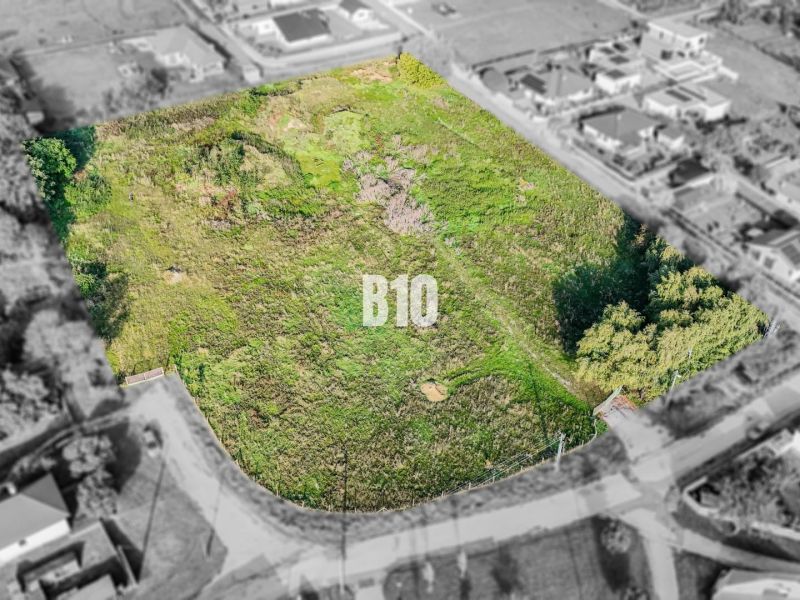 Plots - housing in Nitra with grass cover, surrounded by houses.