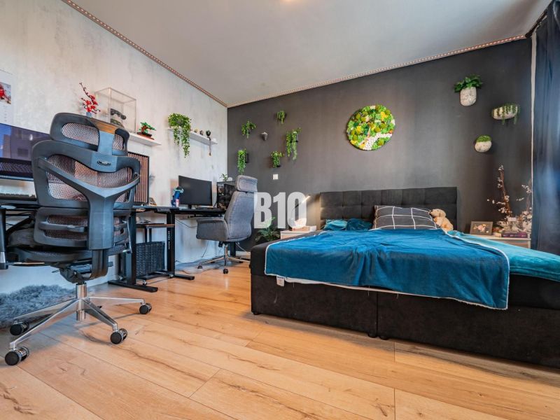 Bedroom of a 3-room apartment with stylish decoration and wooden decor flooring.