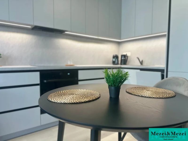 A kitchen in a 2-room apartment with a stylish table and decorations.
