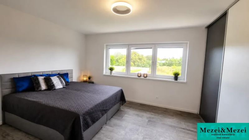Bedroom with a large bed and a view, family house in Trnava.