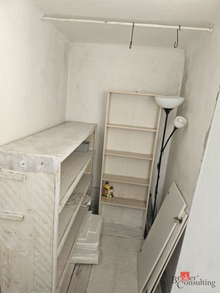 Storage space in a family house with shelves and a lamp.