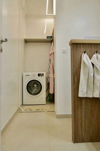 Washing machine with storage space in the bathroom of a 3-room apartment.