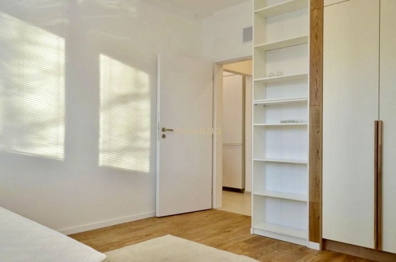 Interior of a 3-room apartment with a shelf and a wooden decor floor.